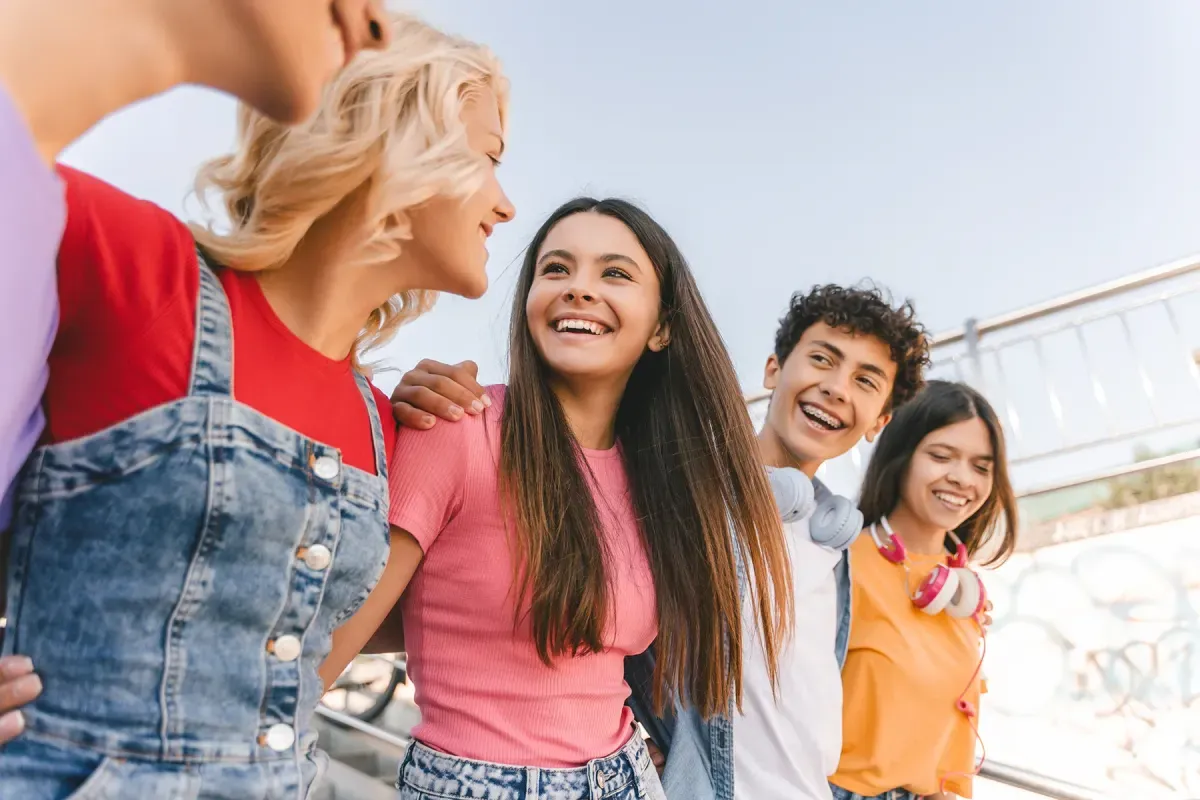 A smiling family standing together outdoors